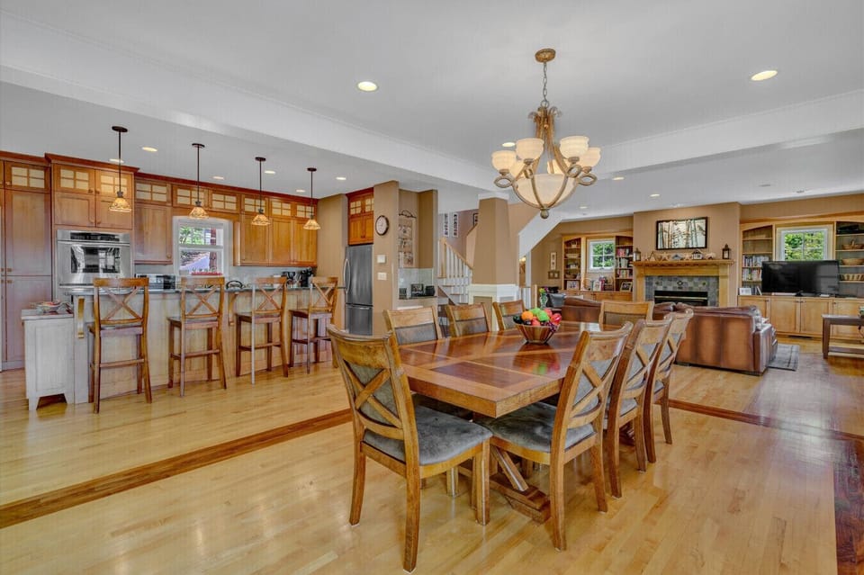 The dining area’s elegant table and ambient lighting create the perfect setting for memorable meal.