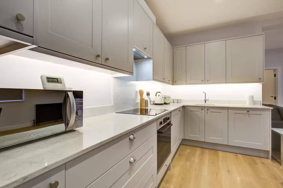Contemporary full kitchen with built-in appliances and ample space