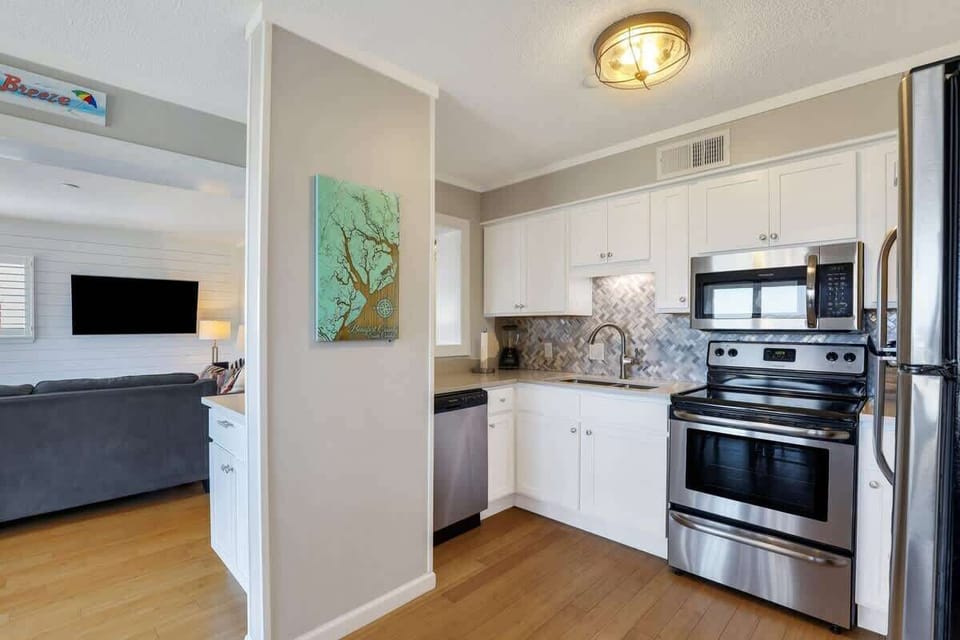 A small "pass-through" window looks into the living area, keeping the floor plan feeling open.
