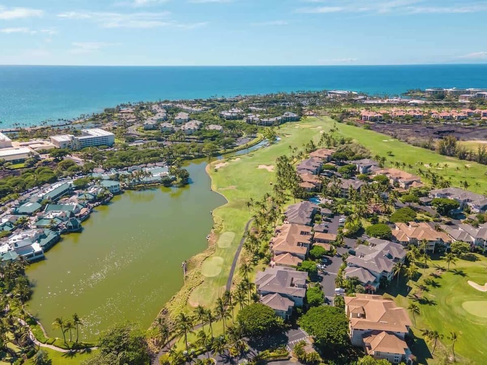 The beautifully landscaped exterior features tropical plants and direct access to the expansive golf course.