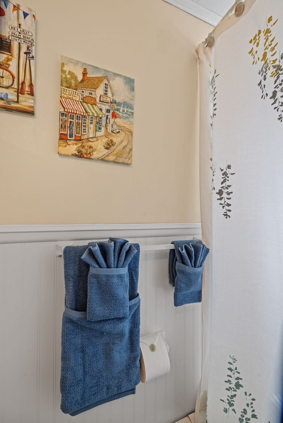 Cape Cod Charm in Every Detail! Thoughtfully arranged towels and coastal artwork bring a relaxing beachy vibe to your morning routine.