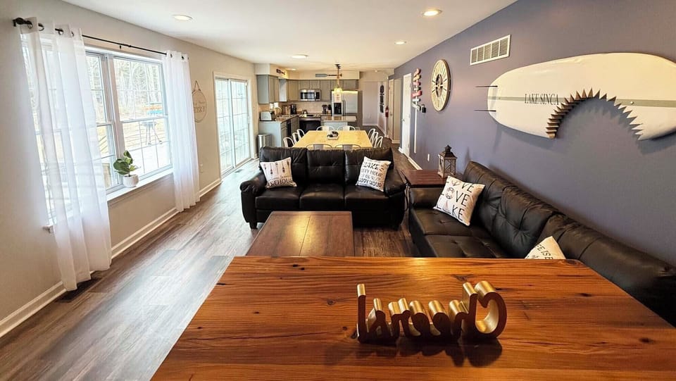 The living room offers breath-taking views of the lake and natural mature trees.
