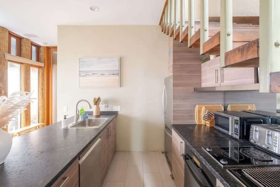 The open, galley-style kitchen comes fully equipped for a long or short stay