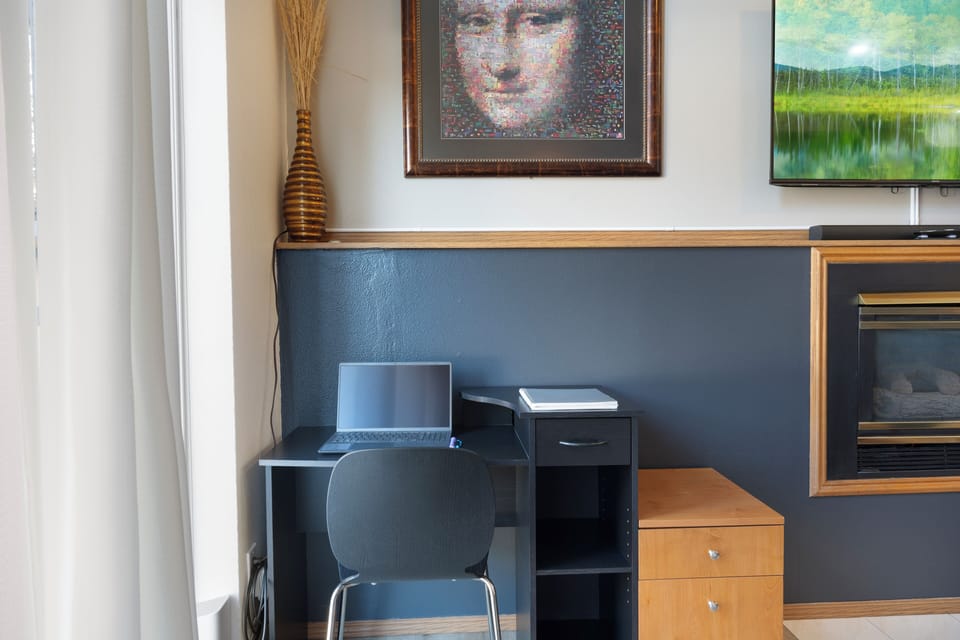 Workspace in the living room with front yard views and easy access to work.