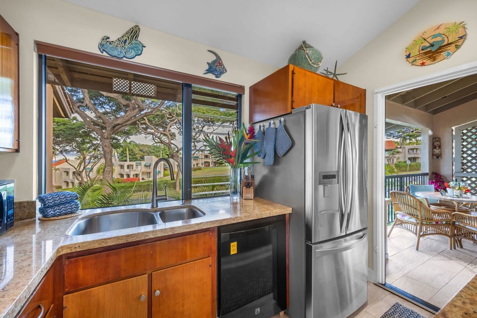 Fully equipped kitchen with stainless appliances and warm wood cabinetry