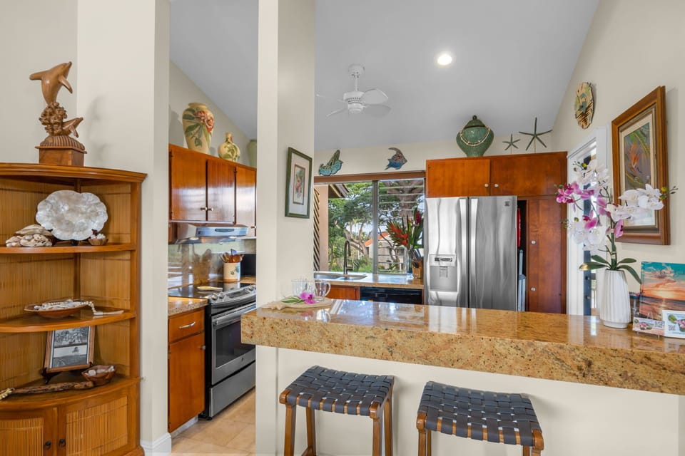 Breakfast bar with granite countertop and seating-perfect for casual meals