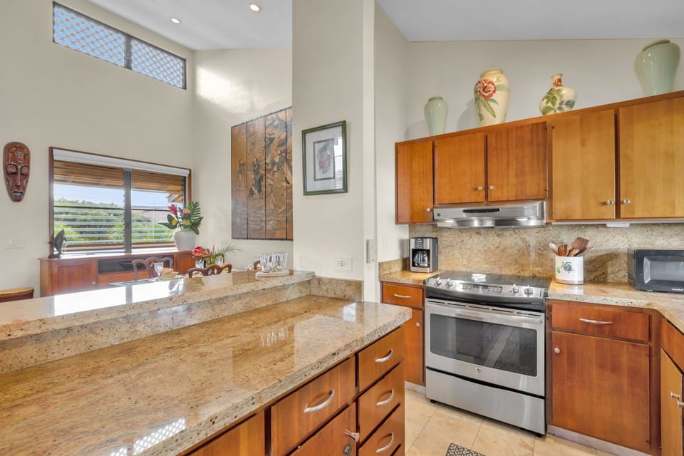 Spacious kitchen with granite counters and easy flow to the dining area.