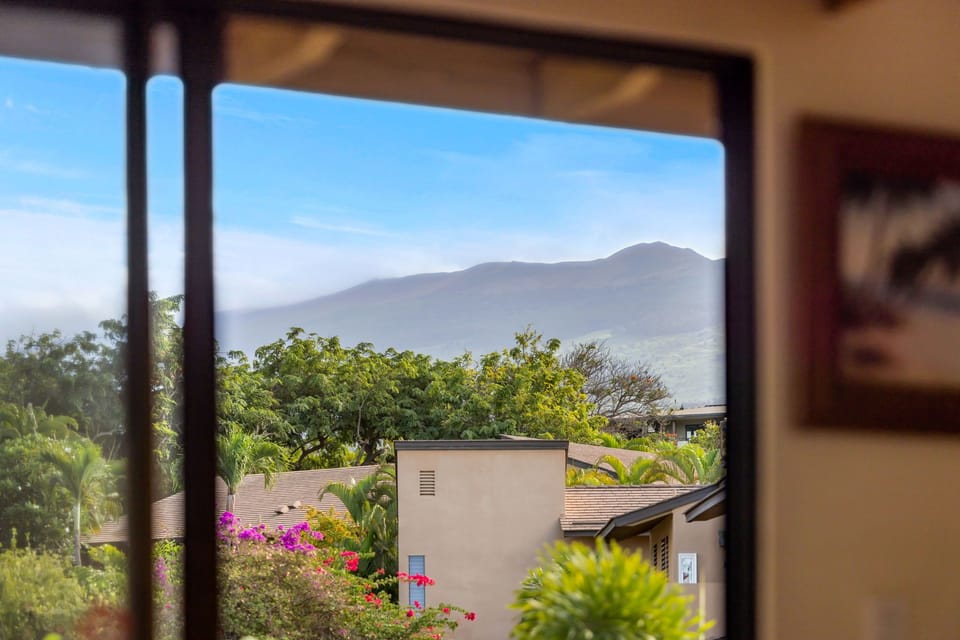 Bedroom window view of Haleakala slopes and tropical landscaping