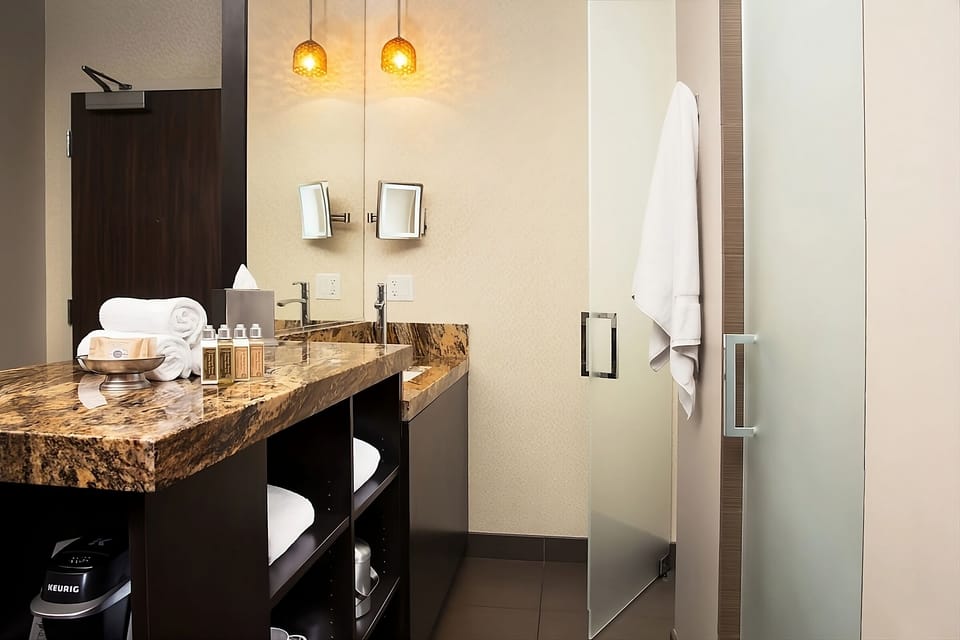 Refresh after adventures with a sleek vanity and glass shower.
