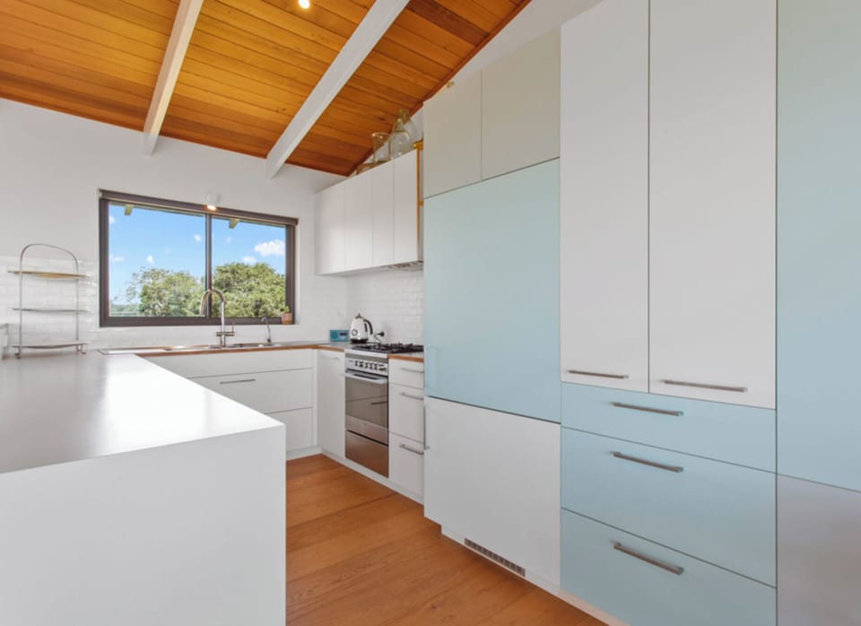 Open planned kitchen with coffee machine, microwave, fridge, gas stove and oven