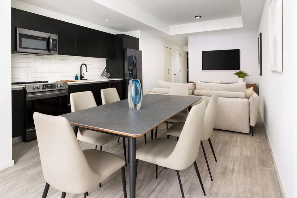Gather for meals at the stylish table beside the kitchen.