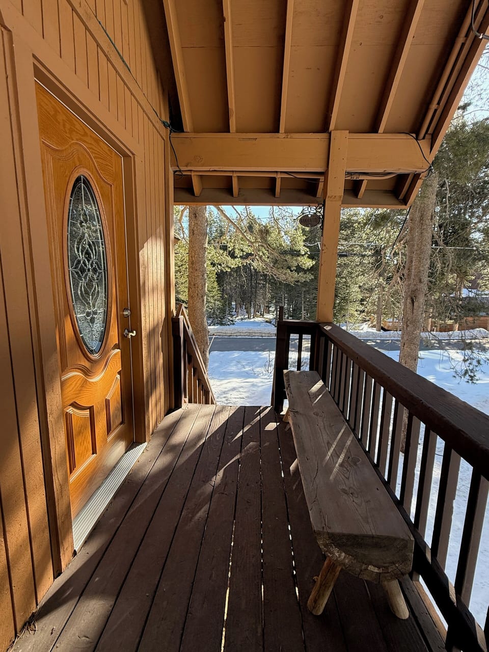 Front door side deck and stairs leading to the driveway.