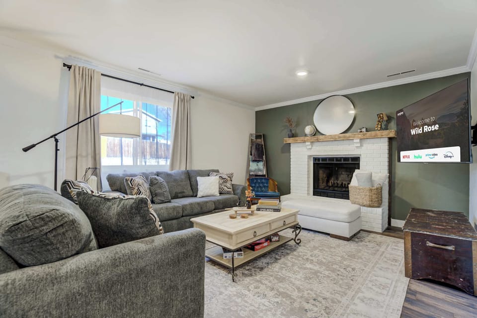 A warm and inviting living room featuring plush seating, a cozy fireplace, and a Smart TV for ultimate relaxation.




