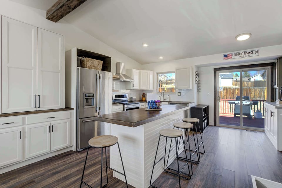 Sleek and spacious kitchen with modern appliances, ample counter space, and bar seating for casual dining!




