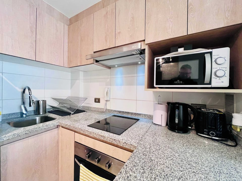 Well-equipped kitchen w/ granite counters, microwave & ample cabinet storage.