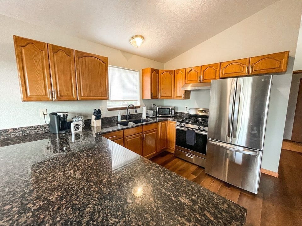 A stocked kitchen with a fridge, microwave, electric range and oven. We also provide the basics such as salt, pepper, cooking oil.