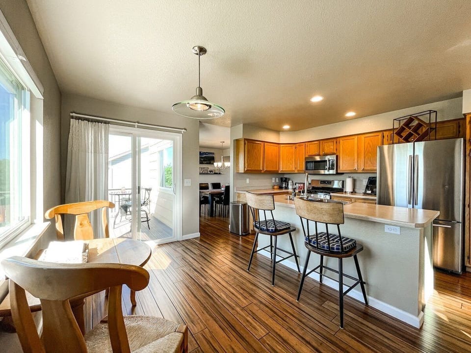Fully stocked kitchen, with barstools at island counter