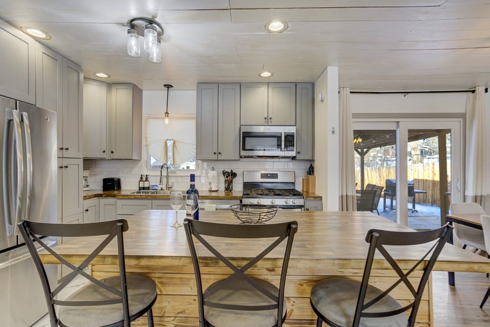 The fully equipped kitchen features stainless steel appliances, new butcher-block countertops, and all the cookware and utensils you need to prepare meals with ease.