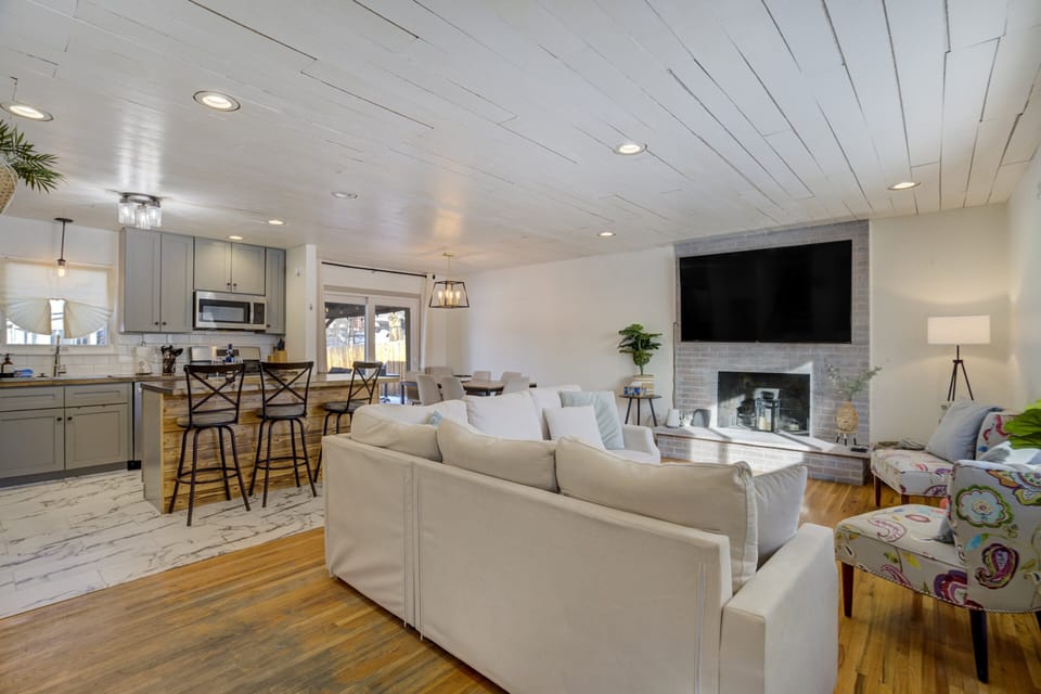 Relax in the bright living room with a large sectional and smart TV