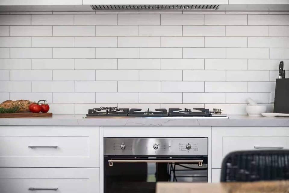 KITCHEN: Quality appliances are a feature with a 900mm cooktop, stone bench top and a pantry with many cooking basics for the chefs convenience.