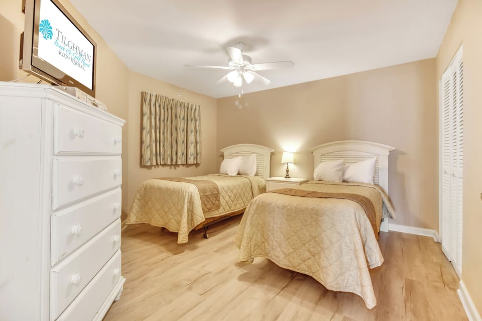 Your peaceful twin bedroom awaits with crisp linens, gentle lighting, and warm coastal touches—perfect for restful nights together.