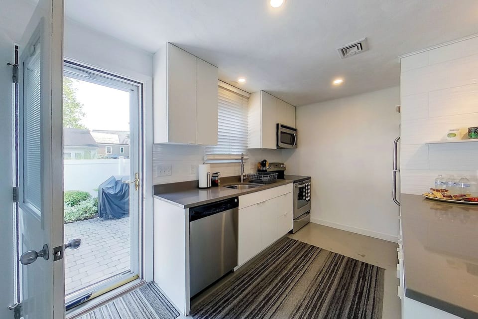 The kitchen opens conveniently to the back patio for easy grilling and al fresco dining. 