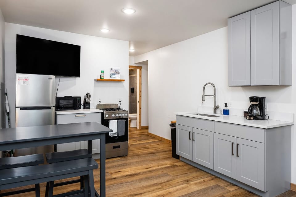 Enjoy cooking in a sleek, modern kitchen equipped with top-of-the-line appliances—perfect for culinary adventures during your Traverse City getaway!