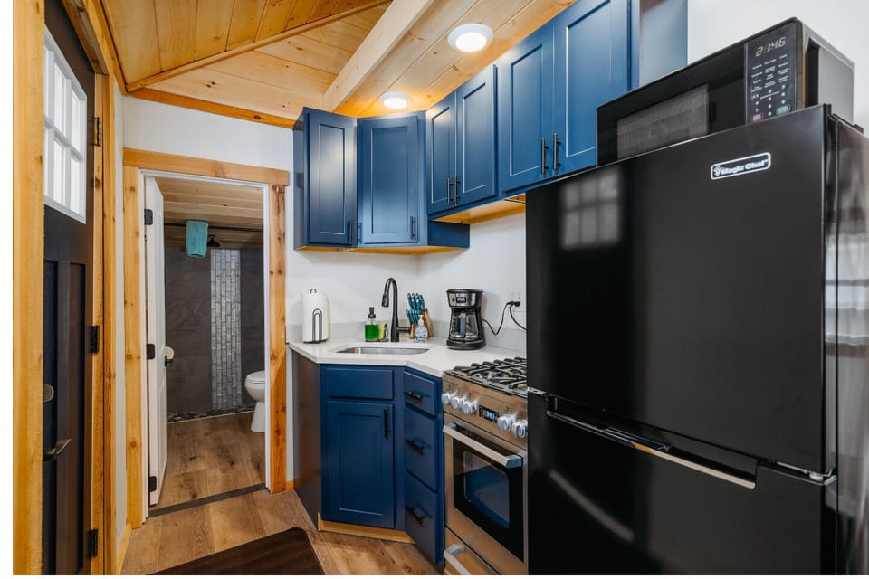 Sleek navy cabinetry, modern appliances, and bright lighting for delightful culinary adventures!
