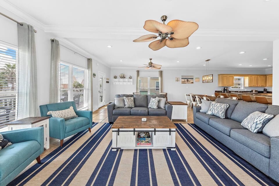 Bright, stylish living room with cozy seating, smart TV, and a cozy vibe