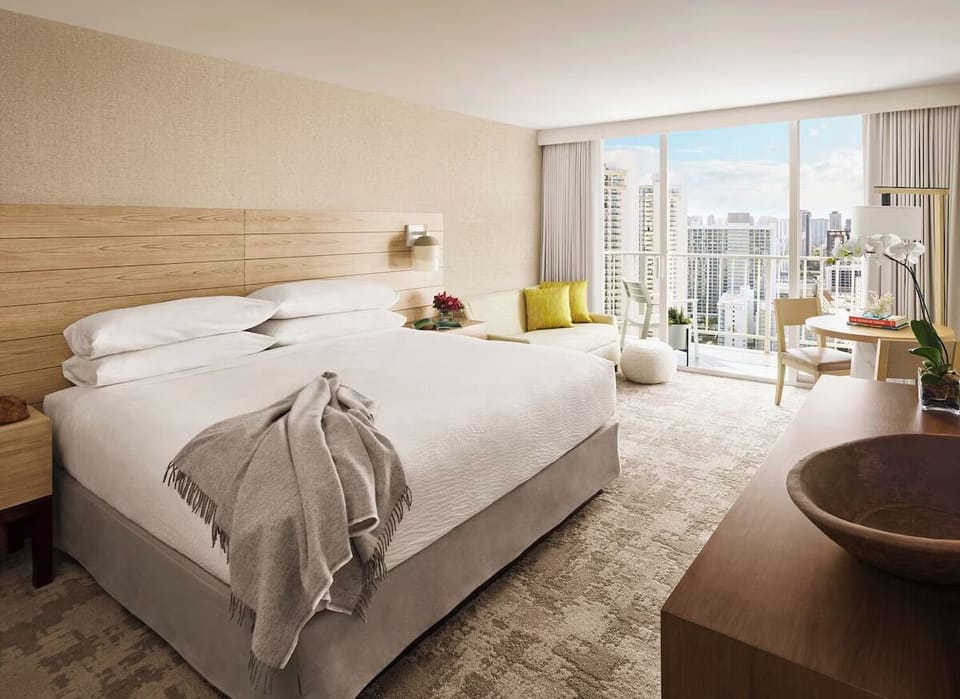 Unwind in airy comfort with skyline views and plush bedding.