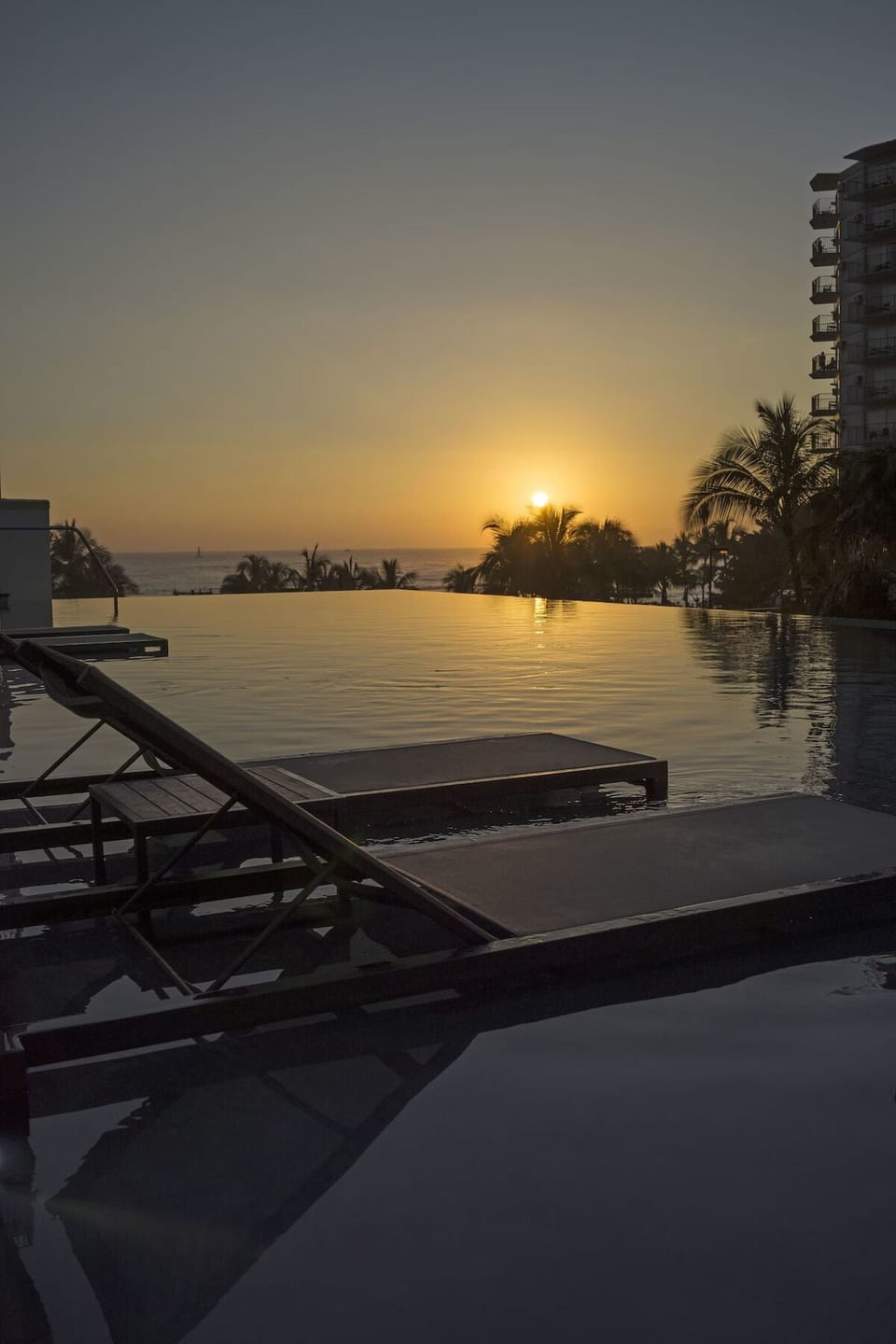Soak in golden-hour calm at the oceanfront infinity pool.