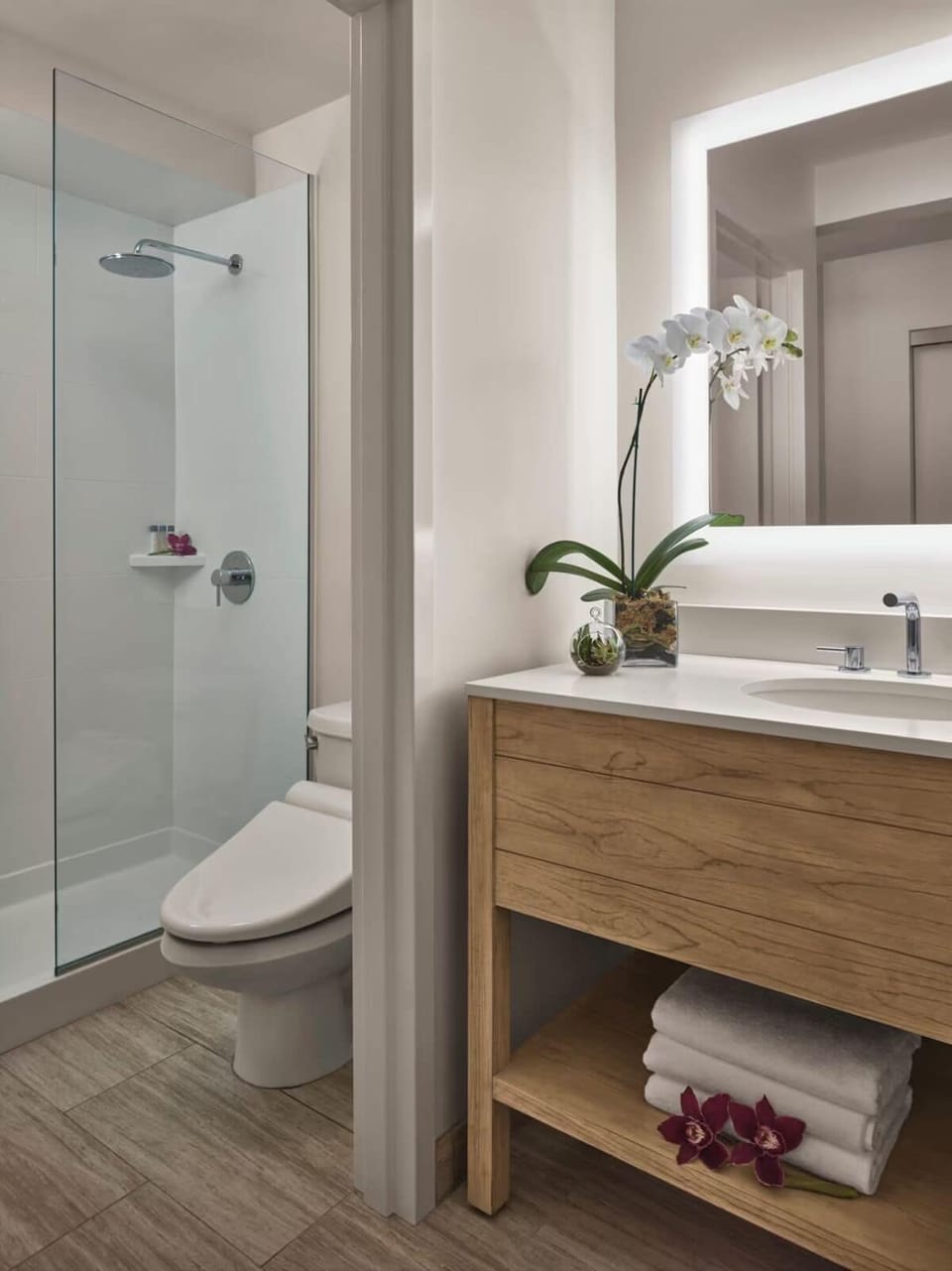 Rinse off in a sleek glass shower with generous space.