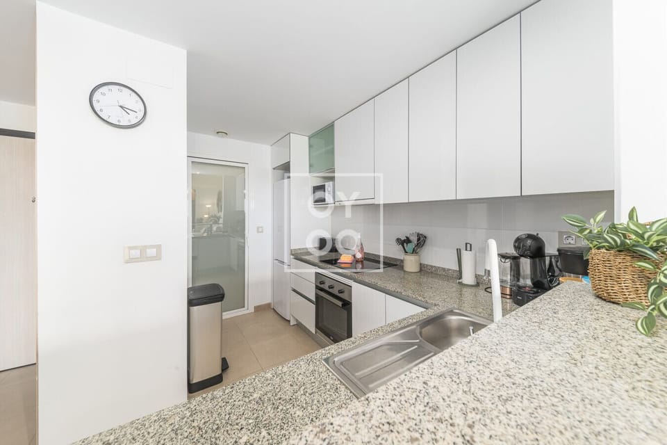 Open-plan kitchen with sleek white cabinetry, built-in oven and fridge, and expansive granite countertops. Thoughtfully placed storage and breakfast bar layout make cooking and socializing effortless 🍳🥂