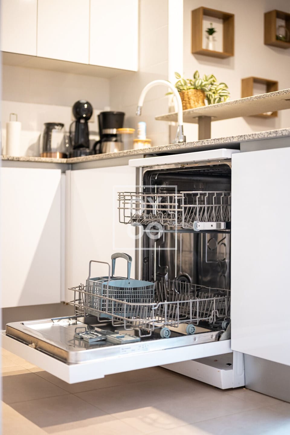Fully integrated dishwasher tucked beneath granite countertops, featuring adjustable racks and a cutlery basket for effortless cleanup. Seamlessly blends with white cabinetry to maintain a sleek, clutter-free kitchen 🧼🍽️