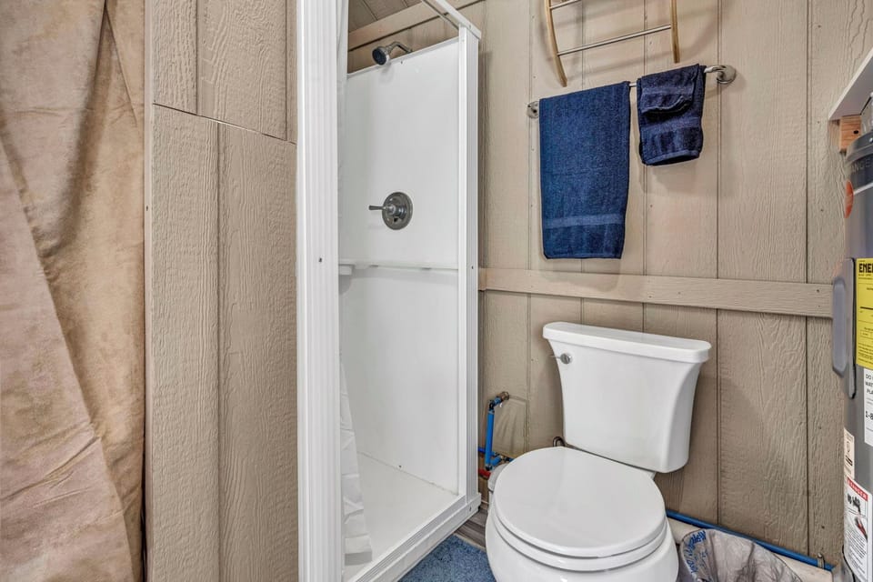 The bathroom is covered by a curtain. No extra doors here :).