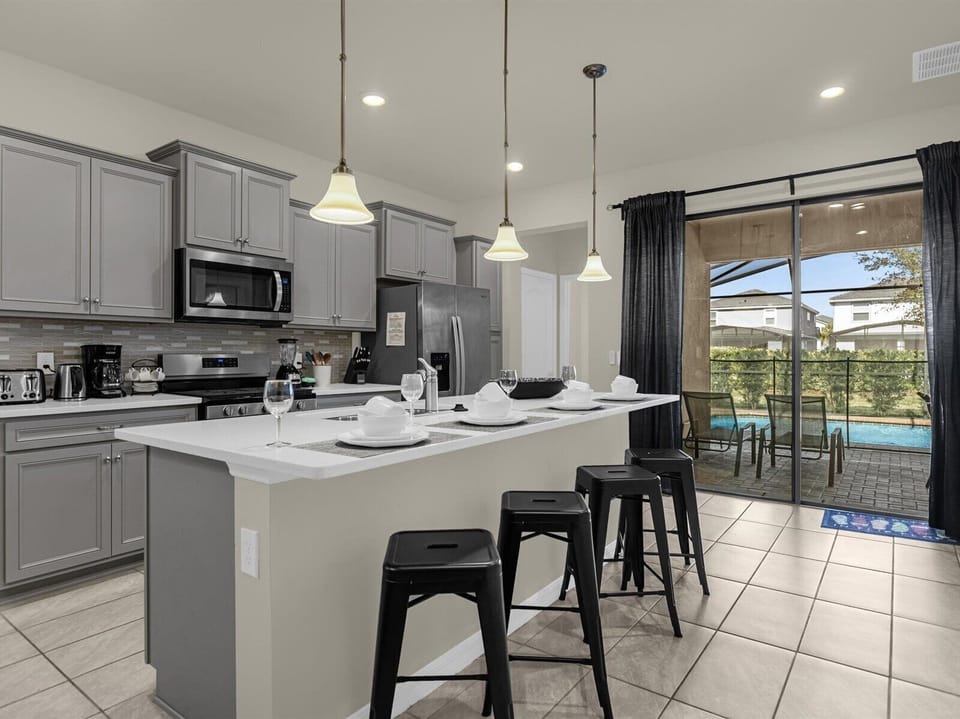 Kitchen | Offers modern appliances, cooking essentials, and convenient counter seating for 4 guests.