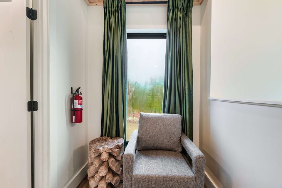A Reading Nook, unwind in style with serene views from your plush armchair and rustic charm nearby!