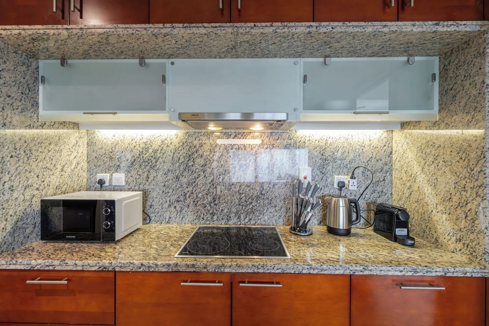Full kitchen, Microwave, Induction cooker, Kettle, Nespresso machine.