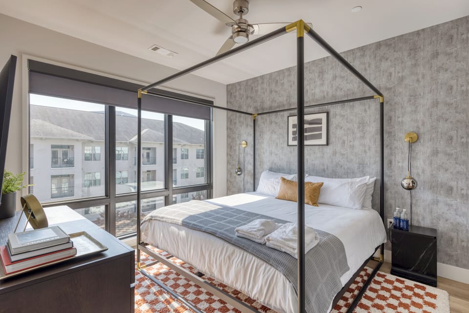The primary bedroom features a king bed, TV, and ensuite bathroom. (Unit 2 - Muse)