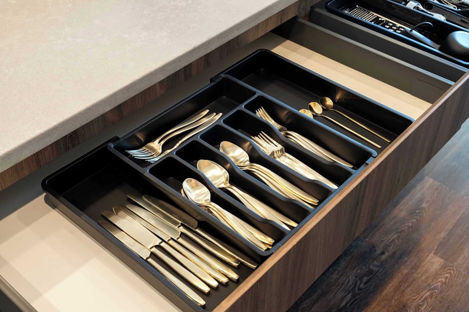Fully equipped utensil drawer designed for convenient cooking prep.