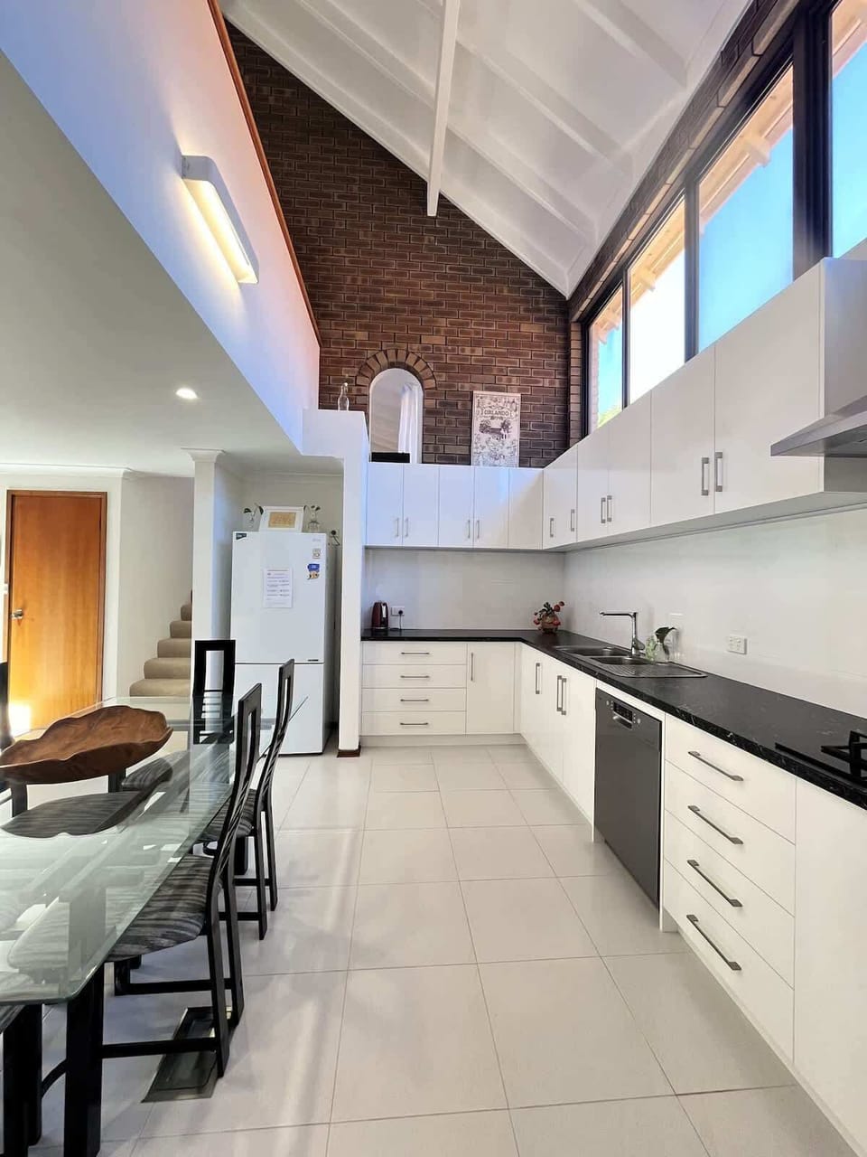 Whip up your favorite meals in our bright and fully equipped kitchen! Featuring ample cabinet space, a convenient sink, a full-sized refrigerator, and a modern stove, it has everything you need for a delightful cooking experience.
