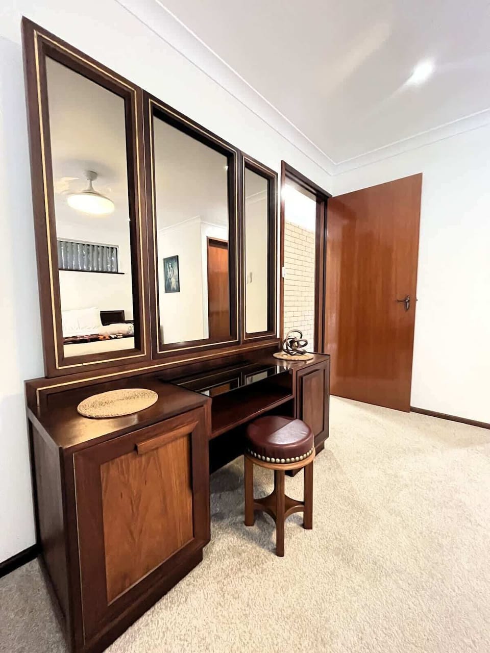 Add a touch of elegance to your routine with this classic wooden dressing table, providing a dedicated space for getting ready.