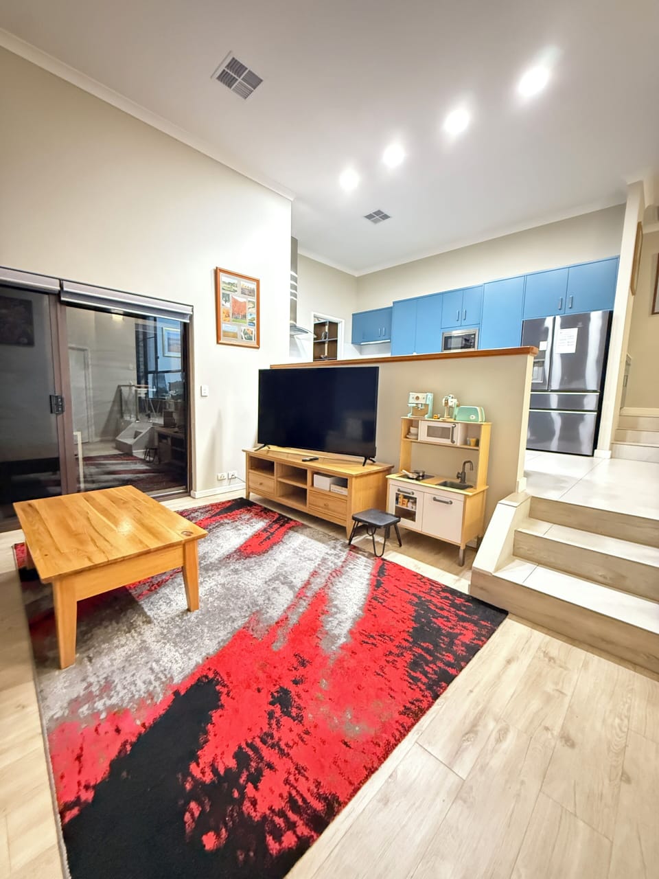 Family-friendly fun awaits! This open-plan home has a large TV for movie nights and a kid's play kitchen. A fully equipped kitchen is just steps away, making it easy to share meals and laughter together.