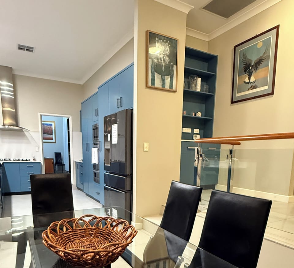 This bright and inviting dining area is conveniently located right off the kitchen, making it the perfect spot for sharing meals. The modern table and chairs create a comfortable space to connect and enjoy your time together.