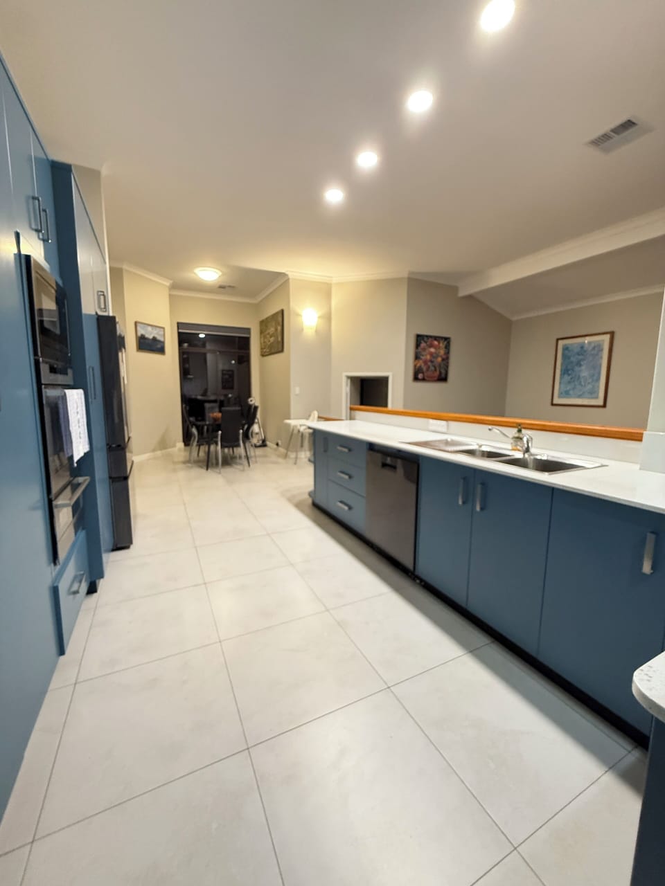 Cook with ease in this spacious, open-concept kitchen. Featuring a double-door refrigerator for all your groceries and a modern built-in oven, it's perfect for preparing meals and entertaining guests.