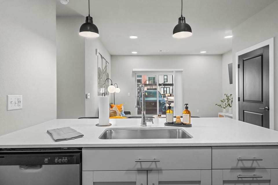 The fully equipped kitchen features sleek, modern appliances and ample counter space, making it easy to prepare your favorite meals or a simple cup of coffee!
