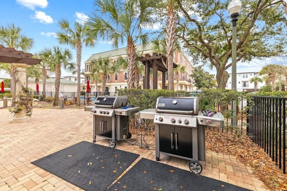 Gas grills by community pool.