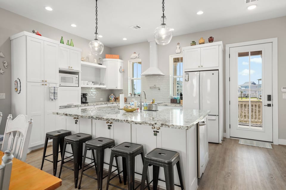 Bar seating at the spacious island in the center of the kitchen
