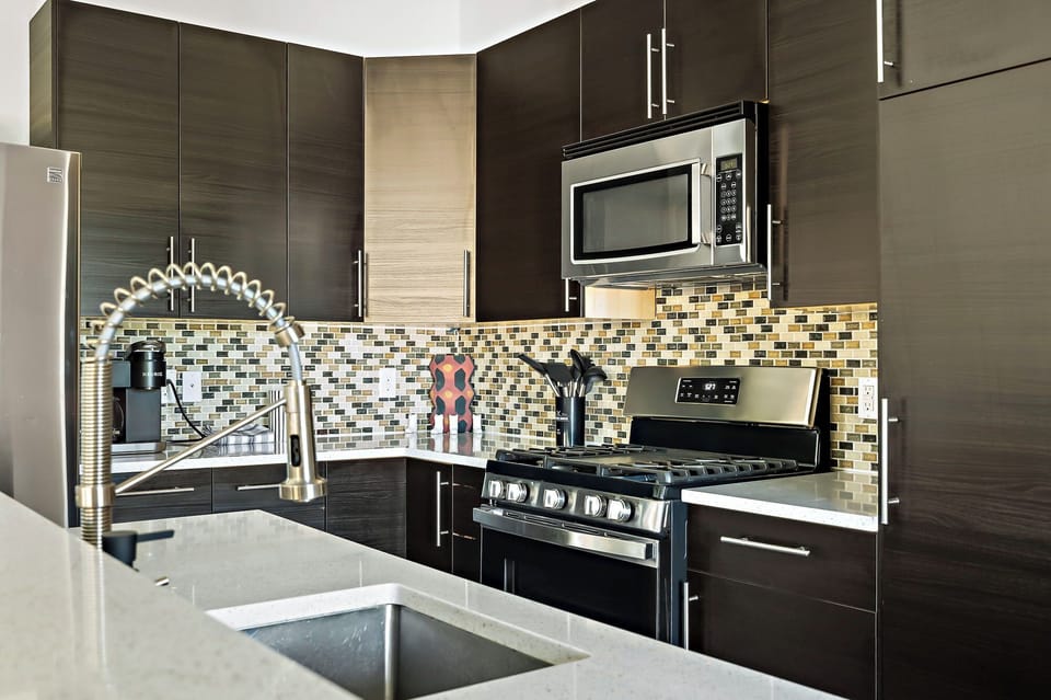 Our cozy Airbnb features a stunning kitchen equipped with stainless steel appliances, perfect for whipping up your favorite meals.