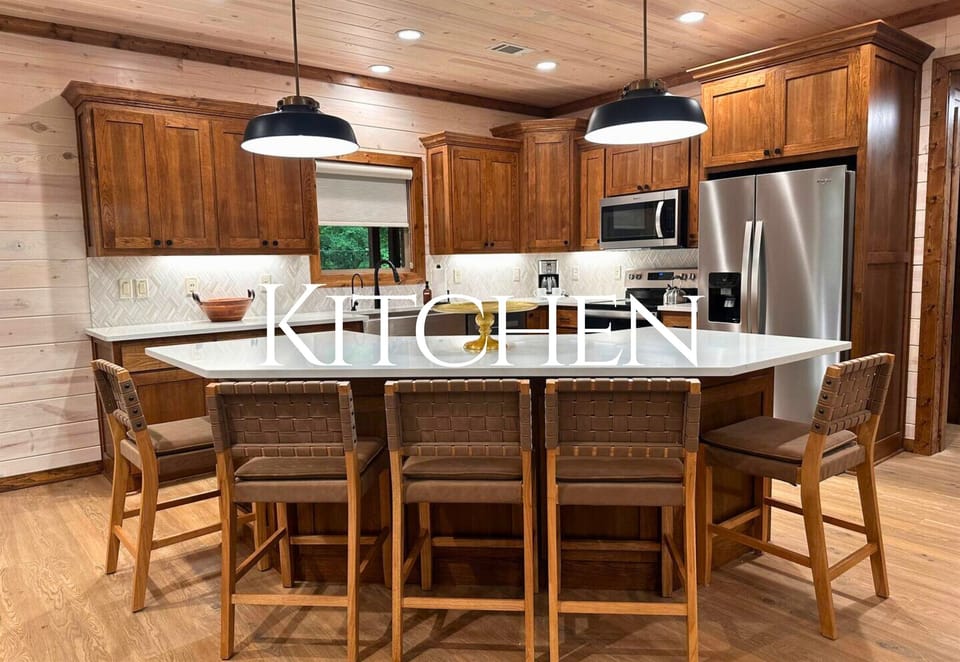 A thoughtfully designed kitchen with rich wood tones, a large island, and modern appliances makes cooking a pleasure.